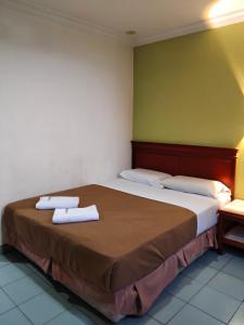 Ένα ή περισσότερα κρεβάτια σε δωμάτιο στο Megah Inn Home Inanam +6 φωτογραφίες