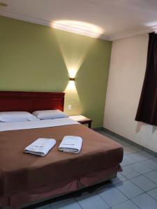 Ένα ή περισσότερα κρεβάτια σε δωμάτιο στο Megah Inn Home Inanam