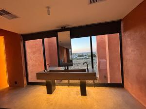 a bathroom with a sink and a large mirror at Prince Albert Tall House in Prince Albert