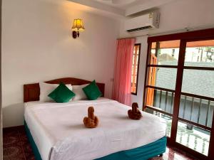 Postel nebo postele na pokoji v ubytování Sangtawan Resort