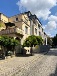 a building on a street with a tree in front of it at Студио Top City Center in Plovdiv