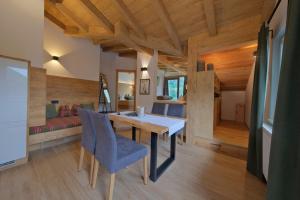 a room with a table and chairs and a bed at Chalet Stubai inklusive Stubai Super Card in Fulpmes