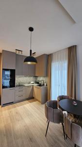 a kitchen and dining room with a table and chairs at Mano jura 2-Apartments in Palanga