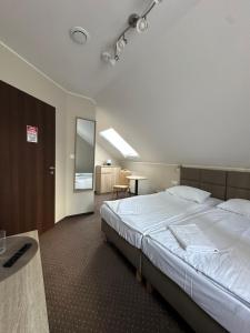 a hotel room with a bed and a desk and a room at GRACJA in Warsaw