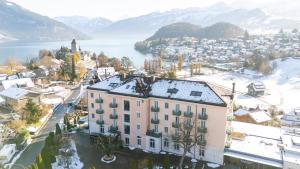an aerial view of a city with snow covered mountains at Hotel Eden Spiez in Spiez