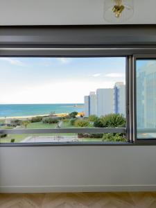 a window with a view of the ocean at L'Ukiyo-e - Vue Mer et Sauna by Alto Service in Le Barcarès