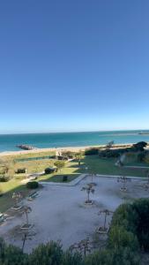 a park with trees in a field with the ocean at Instant à deux - Vue Mer et Sauna by Alto Service in Le Barcarès +16 photos
