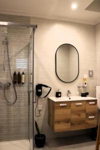 a bathroom with a shower and a sink and a mirror at Zen Loft Getaway in Is-Swieqi