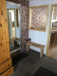 a room with a wooden bench and a mirror at Daislehof in Münstertal
