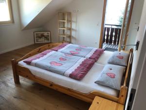 a bed with a quilt on it in a room at Daislehof in Münstertal +9 photos