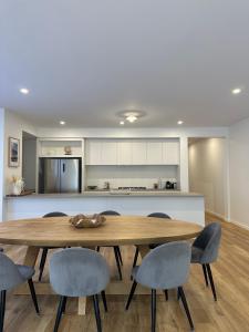 a dining room with a wooden table and chairs at McCrae Retreat Brand New Home in McCrae