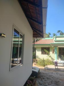 a window on the side of a house at Katadi beach coral cottage in Thanniyam