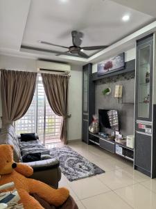 ein Wohnzimmer mit einem Teddybär auf einer Couch in der Unterkunft Kalista1 Seremban 2 in Seremban
