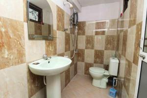 a bathroom with a sink and a toilet at Chrish Residence in Negombo +33 photos