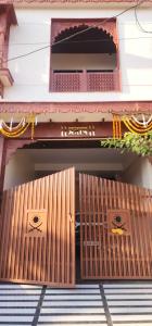 an entrance to a building with wooden doors at Pratap Royal Stay in Ujjain