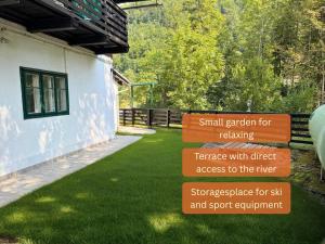 a sign in a yard next to a building at Alpinlake Apartments - Grünau im Almtal in Grünau im Almtal