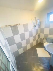 a bathroom with a toilet and a sink at Chrish Residence in Negombo +37 photos