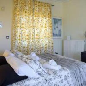 a bedroom with a bed with towels on it at Alba - Open Plan Apartment in Artemida +21 photos