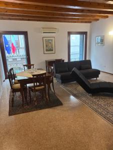 a living room with a couch and a table and chairs at la promenade in Vicenza +12 photos