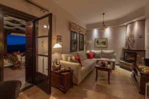 a living room with a couch and a fireplace at Aenaon Villa with Private Pool Panoramic view in Miléai +70 photos