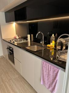 a kitchen with a sink and a counter top at Ayla golf luxury chalet in Aqaba