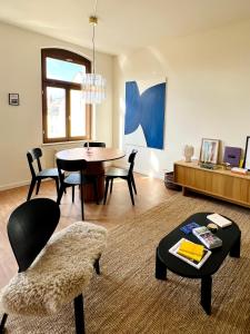 un salon avec une table et une salle à manger dans l'établissement Atelier Noé NOIR - Kunstvoll Wohnen - Wunderbares Frühstück möglich - Ruhig und nah am Zentrum -, à Chemnitz