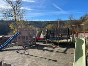 a playground with a slide and a swing set at Апартамент Lina View in Tryavna