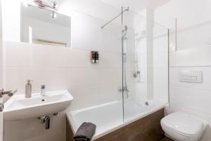 Un baño blanco con lavabo e inodoro. en ChillCouture Chillen an der Zeche Zollverein, Chilling at Zeche Zollverein close to downtown, en Essen