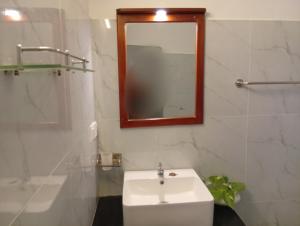Un baño con un lavabo blanco y un espejo. en Crystal Waters, en Habaraduwa Central 4 fotos más