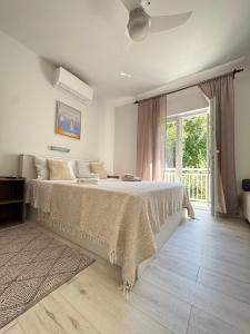a bedroom with a bed and a large window at Rose rooms on the island of Rab in Rab