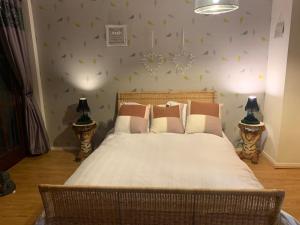 a bedroom with a bed and two lamps on tables at 2 Bed Duplex Penthouse Apartment by Mathew Street Sleeps 6 in Liverpool