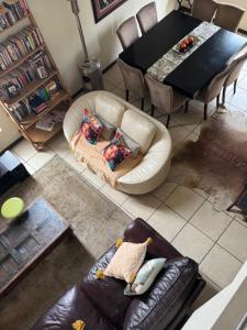 a living room with a leather couch and a table at Mona Lisa No5 in Polokwane