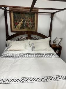 a bedroom with a bed with a painting on the wall at PARADISE in IR YAMIM in Netanya +19 photos
