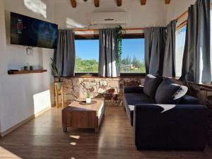 a living room with a couch and a table at Villa Bella vista 2024 in San Rafael