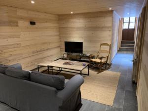 a living room with a couch and a table at Chalet Suvay in La Chapelle-dʼAbondance
