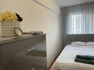 a bedroom with a bed and a vase on a counter at Apartamentul lui Radu in Caracal