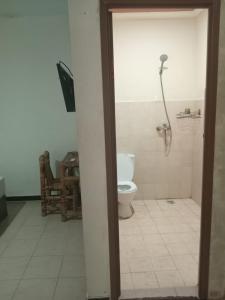 a bathroom with a toilet and a phone at Malaka ocean homestay in Kuta Lombok +40 photos