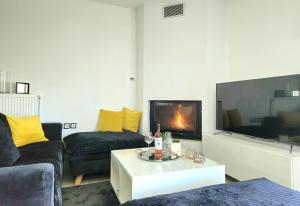 a living room with a couch and a tv at Mary's luxury apartment Nemea 1 in Neméa