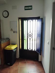 a black door with a gate in a room at Capricho Azul in Conil de la Frontera