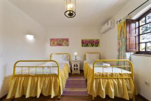 a bedroom with two beds and a window at Villa Monte Domingos Simoes in Sesmarias +50 photos