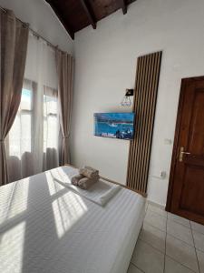 a bedroom with a bed with a towel on it at Palm Villa in Skala Sotiros +19 photos