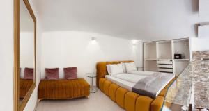 a bedroom with a large bed and a mirror at VIP Jacuzzi Suites in Budapest +76 photos