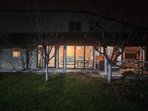 a building with two trees in front of it at Casuta Din Poveste Gold Craiova in Craiova