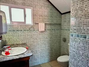 a bathroom with a sink and a toilet at Relax in Paradise in Victoria +3 photos