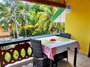 a table and chairs in a room with a window at Relax in Paradise in Victoria