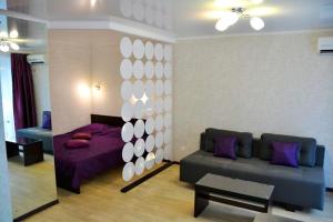 a living room with a couch and a bed at Exclusive apartment at the in Mykolaiv