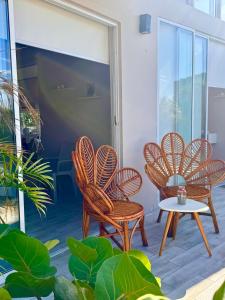 a group of chairs and a table on a patio at Ribera Del Norte Bungalows in Canoas