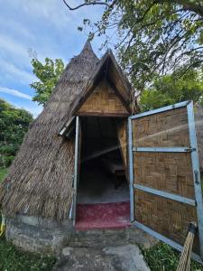 a small hut with a thatched roof at The Last Resort in Don Det +3 photos
