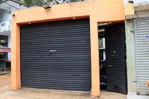 a pair of garage doors on the side of a building at Skylar Homestay - Comfortable Room with Balcony in Panwila Kandy in Panwila