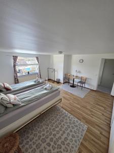 a bedroom with a large bed and a table at M & M home in Karlshamn +13 photos